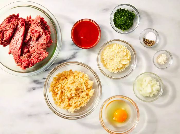 Ingredients for Low-Carb Meatloaf with Pork Rinds displayed in glass bowls