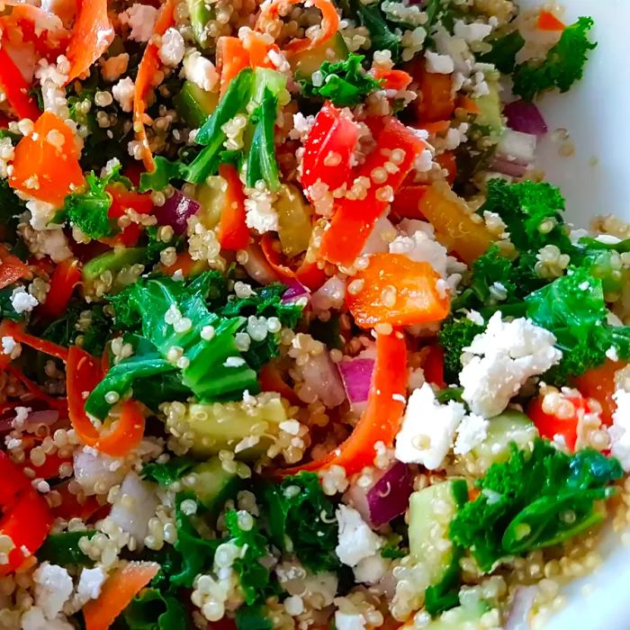 A close-up shot of the Kale, Quinoa, and Avocado Salad with Lemon Dijon Dressing in a bowl