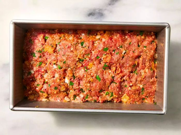 Uncooked Low-Carb Meatloaf with Pork Rinds placed in a loaf pan