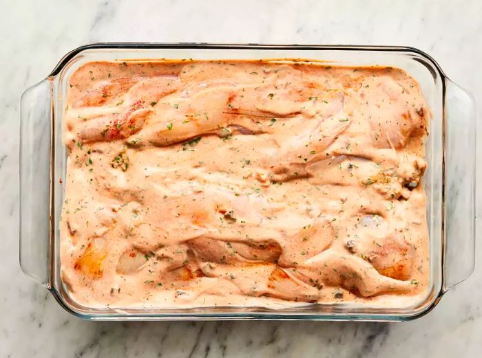 Condensed soup, milk, and parsley blended together and spread over the chicken pieces.