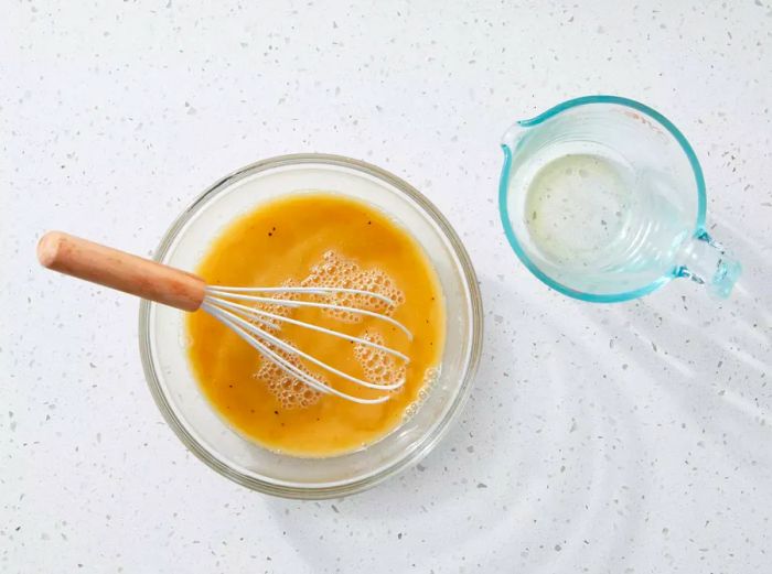 The remaining flour is whisked into the beef broth until it becomes smooth.