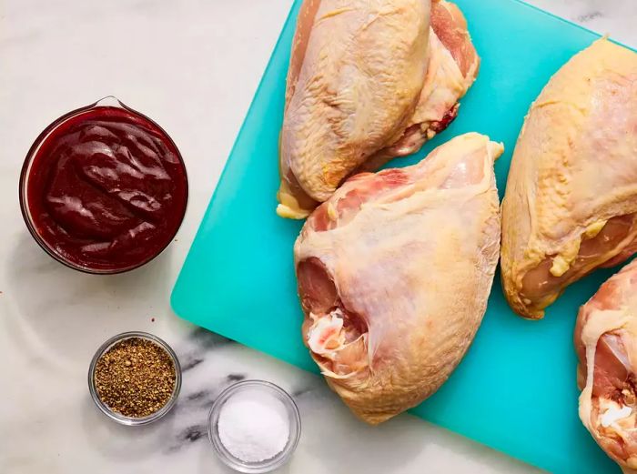 All ingredients are prepared for making BBQ chicken breasts in the oven.