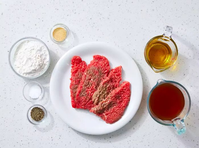 All the ingredients are ready for preparing the country-style steak.