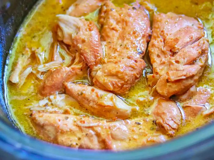 chicken cooked in Italian dressing sauce in a crockpot