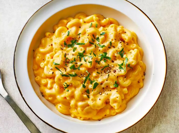 a top-down shot of a bowl of creamy macaroni and cheese