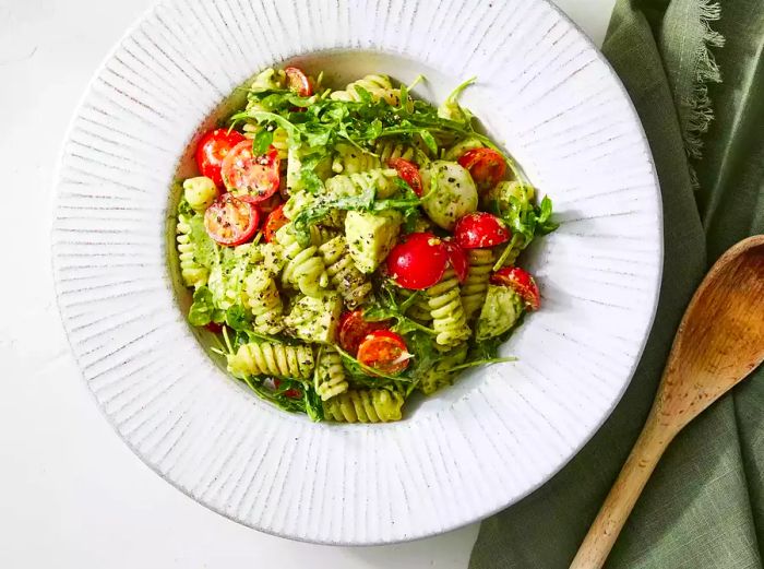 a top-down view of a bowl of pesto pasta