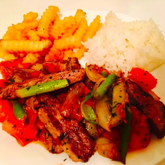 a high-angle shot of Peruvian lomo saltado on a plate