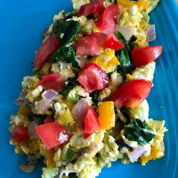 egg scramble with spinach, tomatoes, onions, and feta