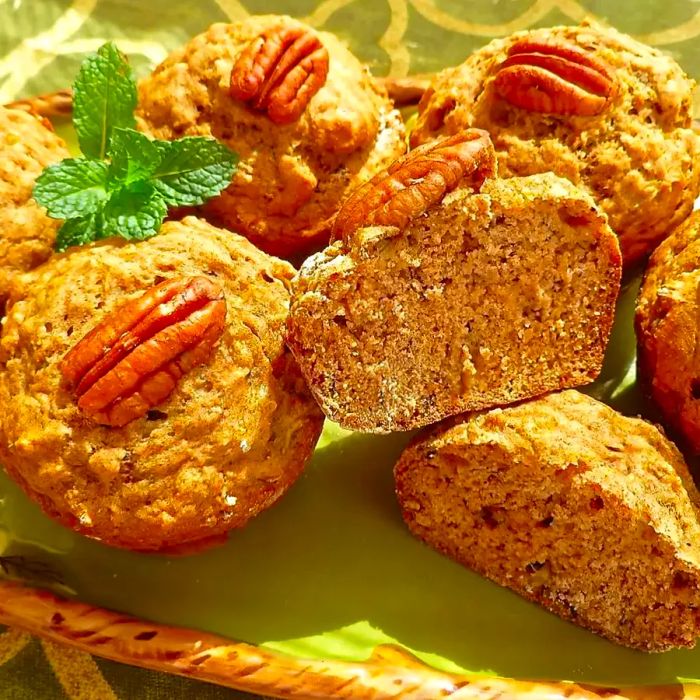 banana nut muffins topped with pecans