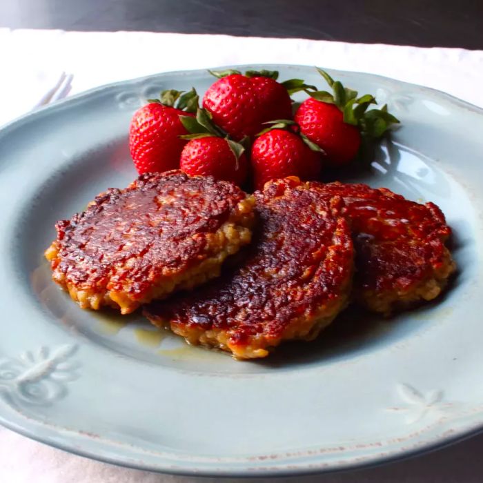 three oatcakes on a blue plate with strawberries