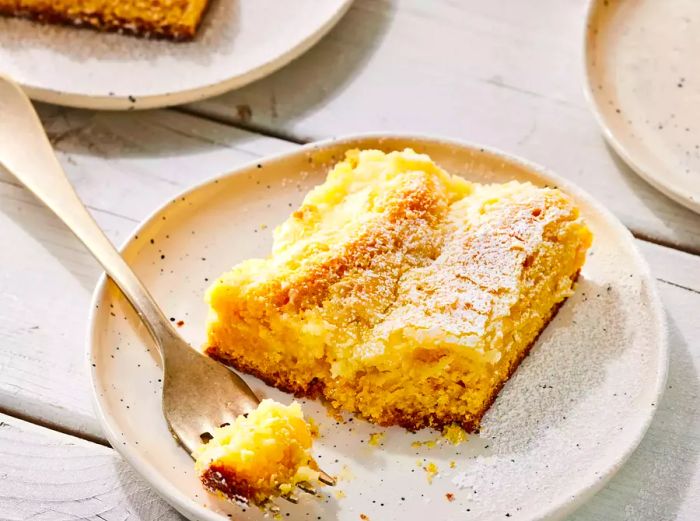 A close-up shot of a gooey butter cake on a plate.