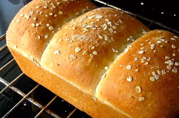 Light Oat Bread with a delicate oatmeal topping on a cooling rack