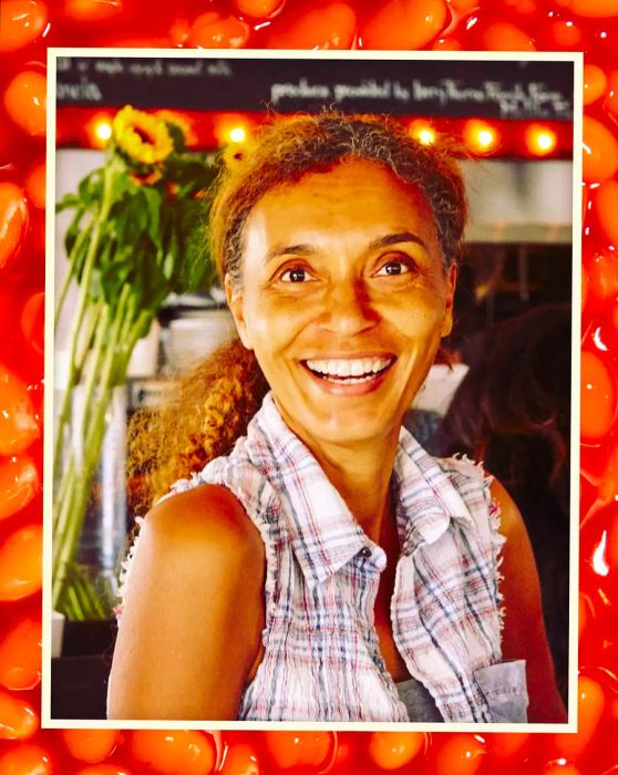 Helene Henderson smiling, wearing a sleeveless shirt