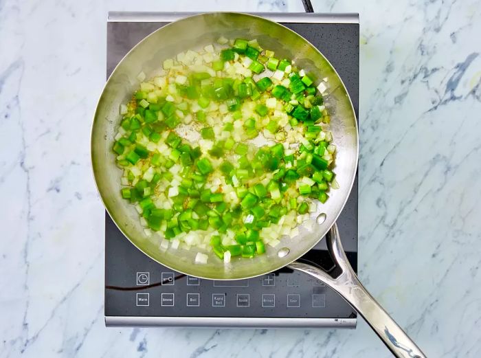 Onion, bell pepper, celery, and garlic cooked for 3 to 4 minutes.