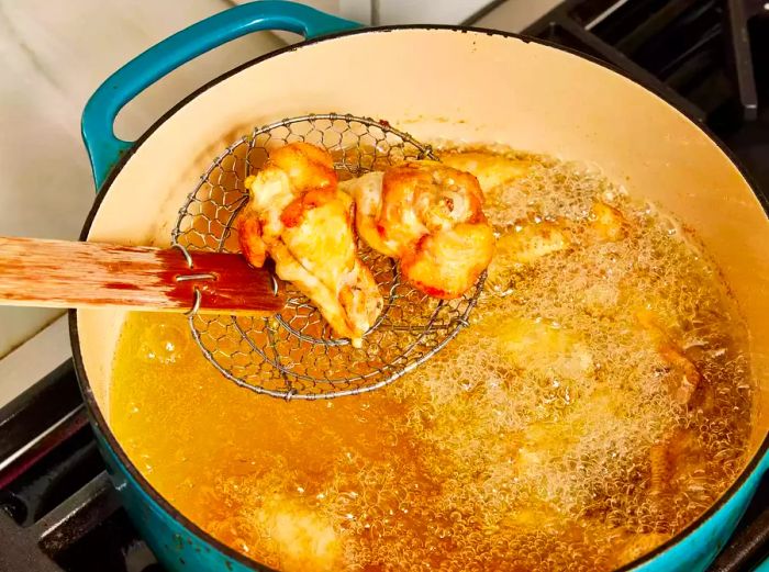 chicken wings frying in hot oil