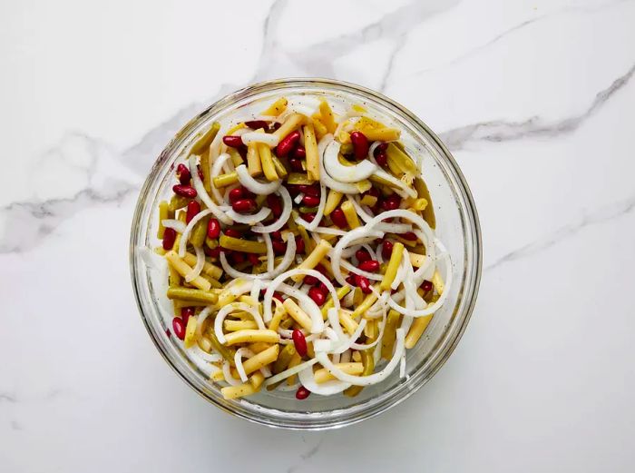 An overhead view of the three bean salad, now mixed and resting in a bowl.