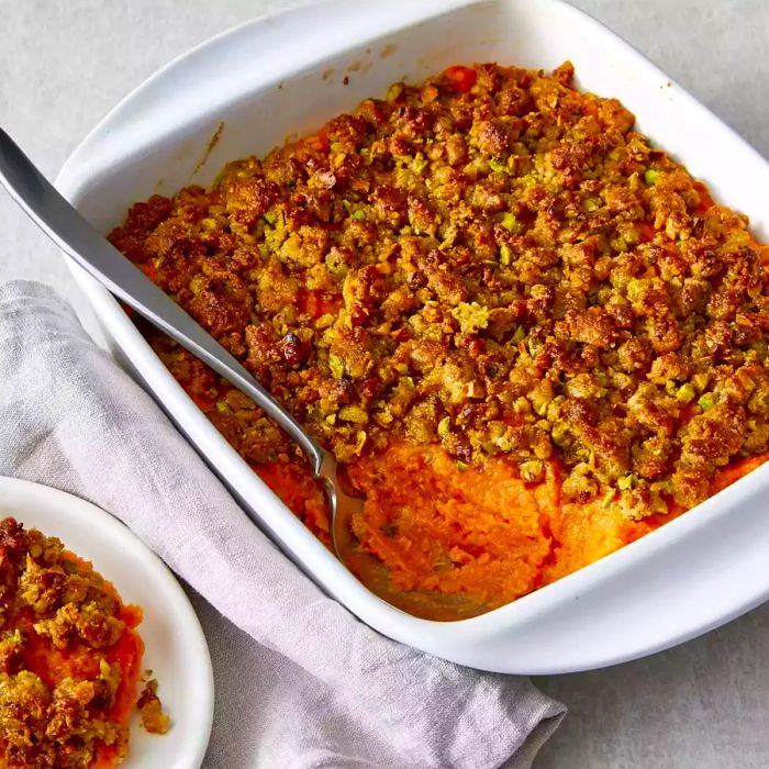 Chef John's Sweet Potato Casserole served in a white baking dish