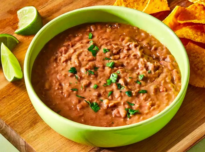 a generous bowl of refried beans, topped with fresh chopped cilantro