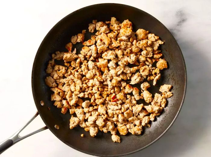 A pan with browned ground turkey