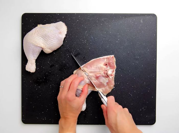 Separating the chicken leg from the thigh