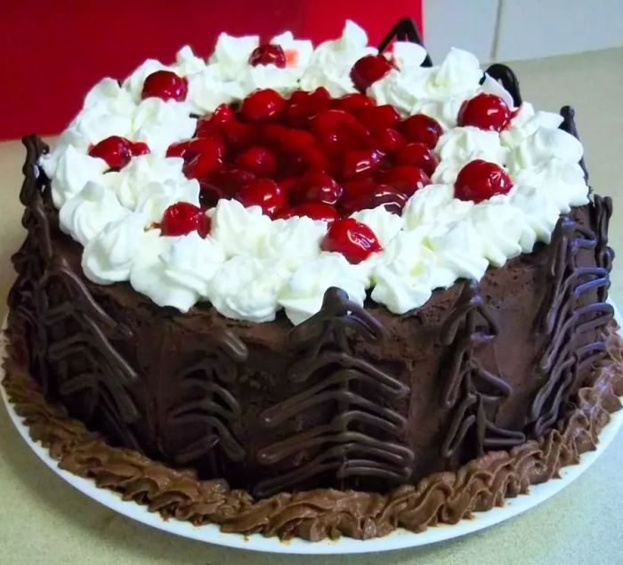 Jenny's Black Forest Cake displayed on a white cake stand