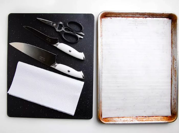 knives, paper towel, and parchment-lined pan