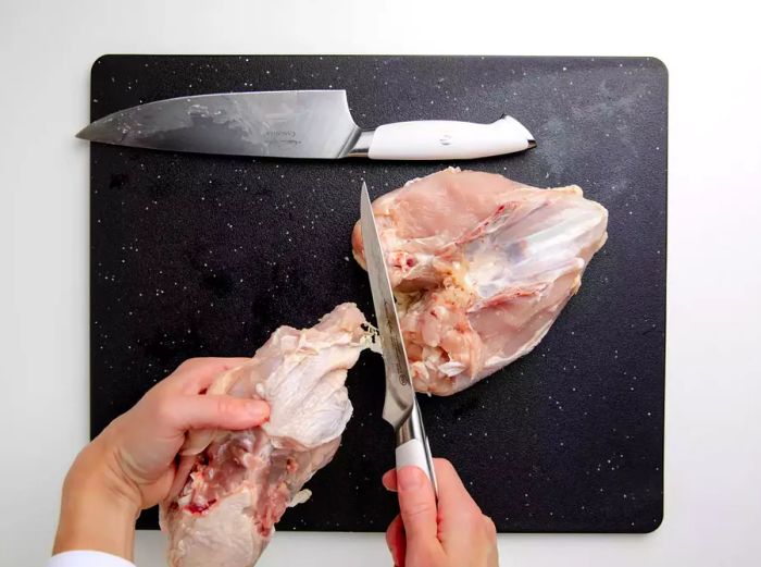 Removing the backbone from the whole chicken