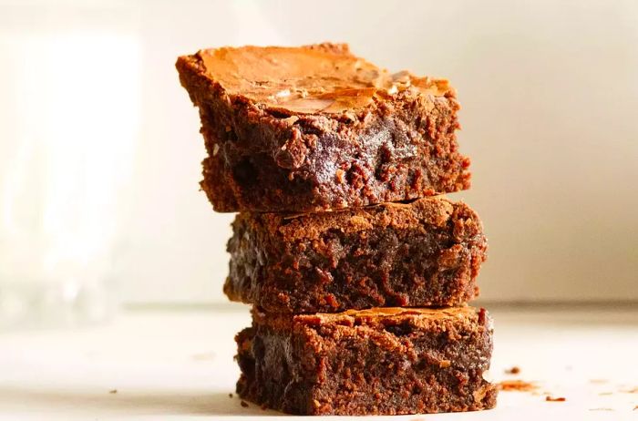 a stack of freshly baked brownies made from a boxed mix