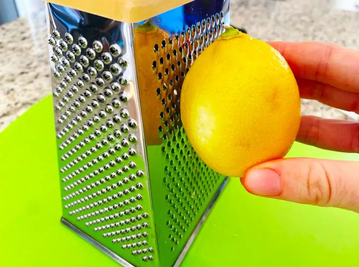 Grating lemon zest with a box grater