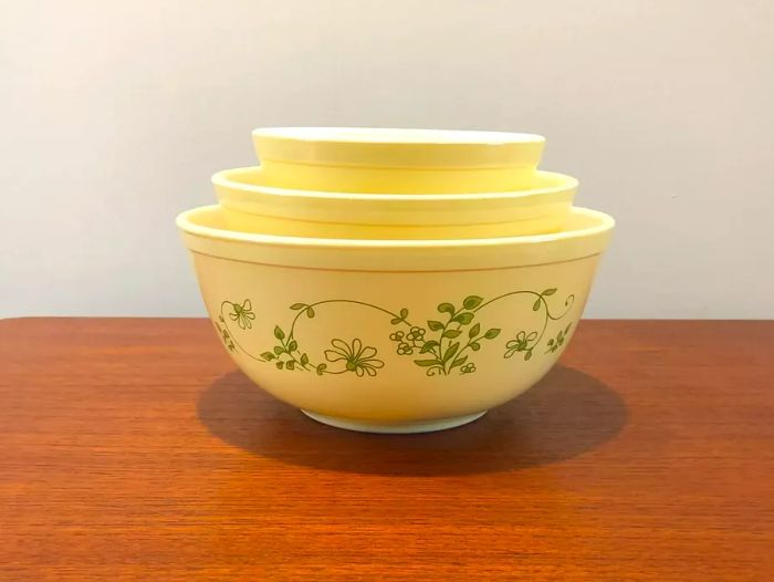 Vintage opal-colored mixing bowls featuring a spring-inspired green design