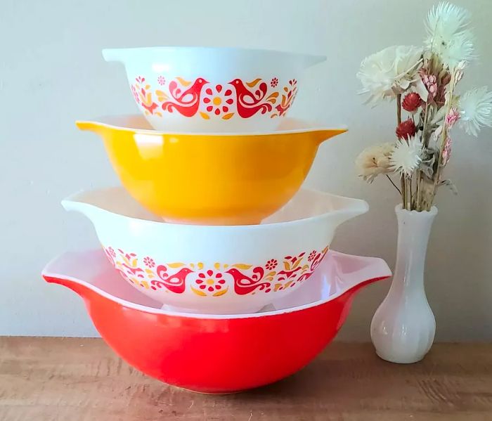 Bold yellow and orange mixing bowls featuring a whimsical bird pattern