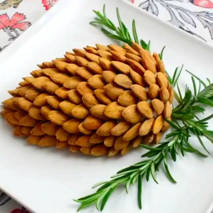 cheese ball shaped like a pine cone with almonds