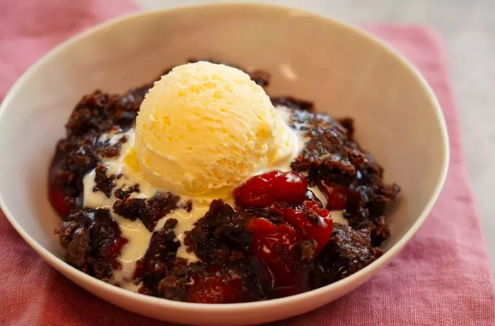 portrait shot cherry chocolate dump cake with ice cream