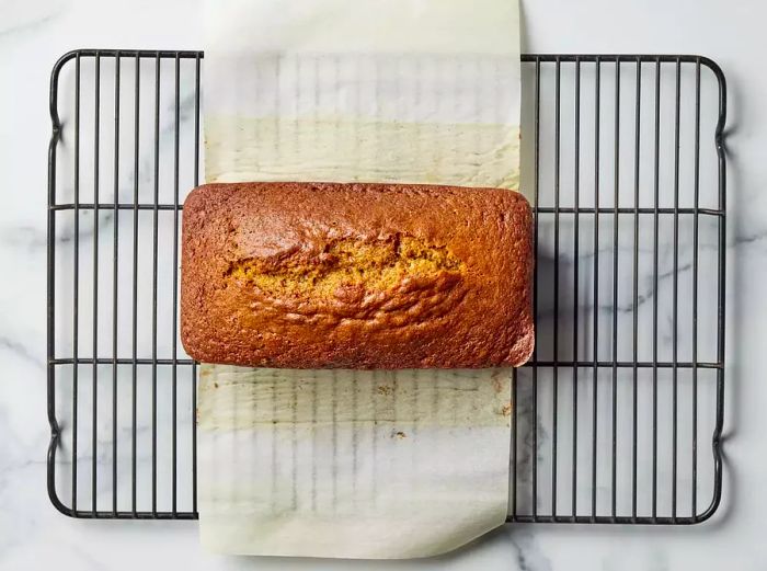 Pumpkin bread cooling on a wire rack after baking.