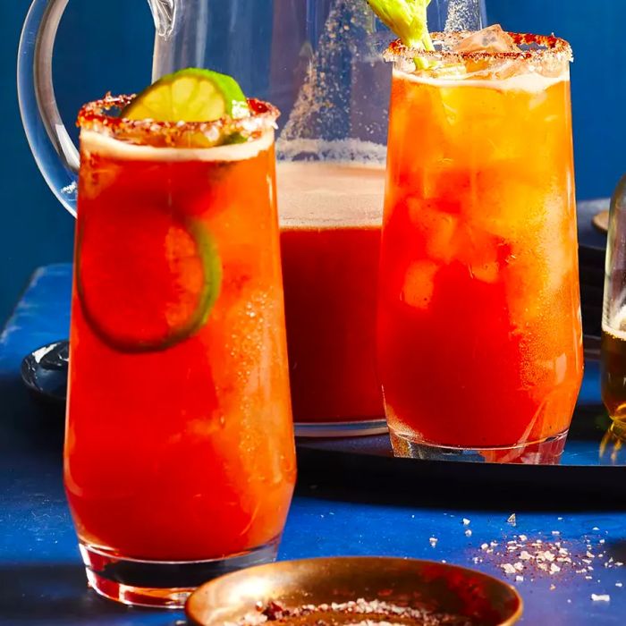 Two glasses and a pitcher of Chef John's Sunset Michelada ready to serve.