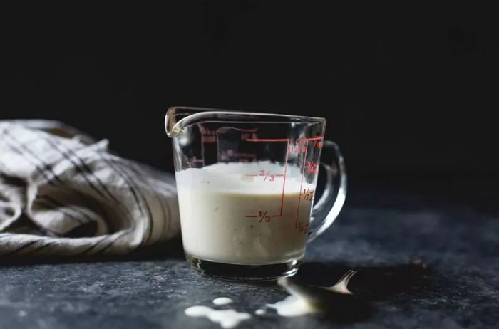 A measuring cup filled with buttermilk