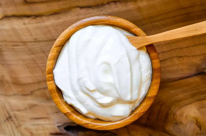 A healthy breakfast featuring fresh Greek yogurt on a light background