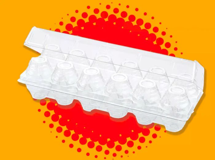 An empty plastic egg carton set against a vibrant orange background