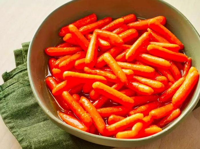 A bird's-eye view of sweet baby carrots in a large bowl.