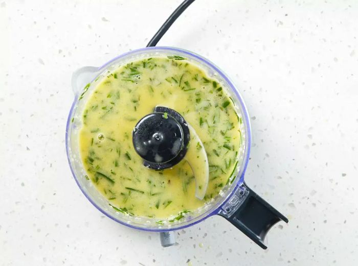 The lime juice, olive oil, sherry, rosemary, and garlic are blended in a food processor until the garlic is finely chopped.