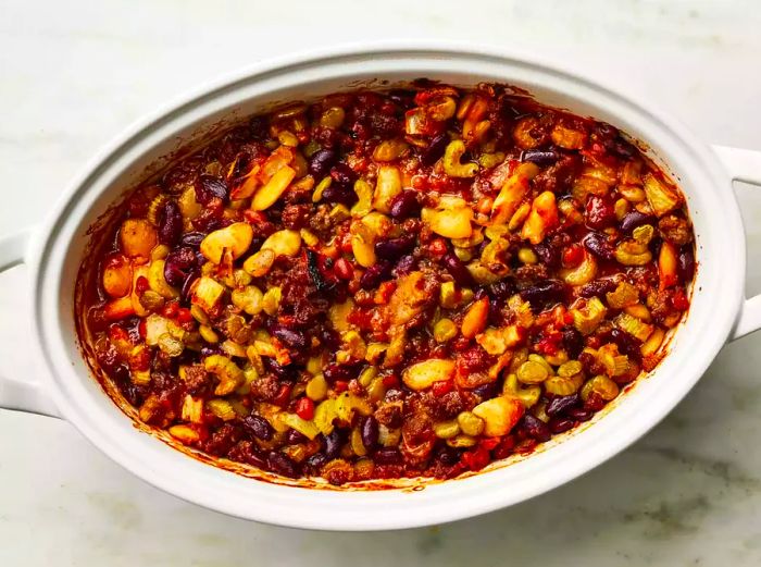 A casserole dish of golden-brown baked calico beans