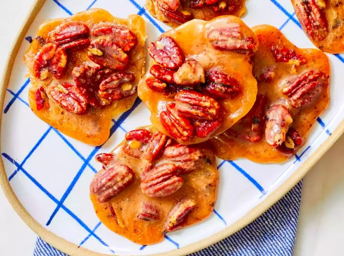 A stack of pralines topped with pecans