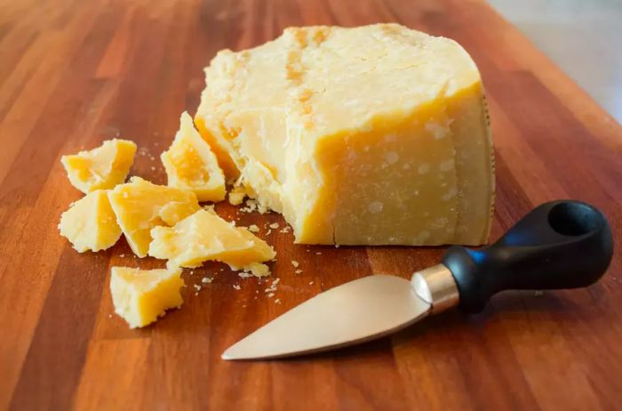 Chunks of Parmesan on a wooden cutting board