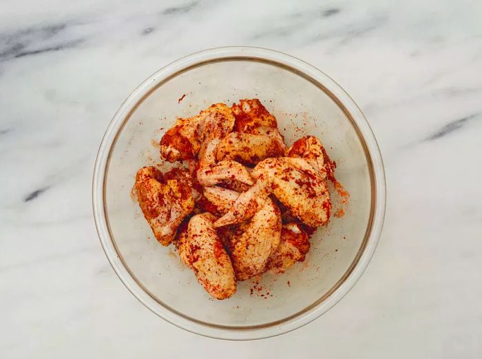 Seasoned chicken wings ready for cooking.