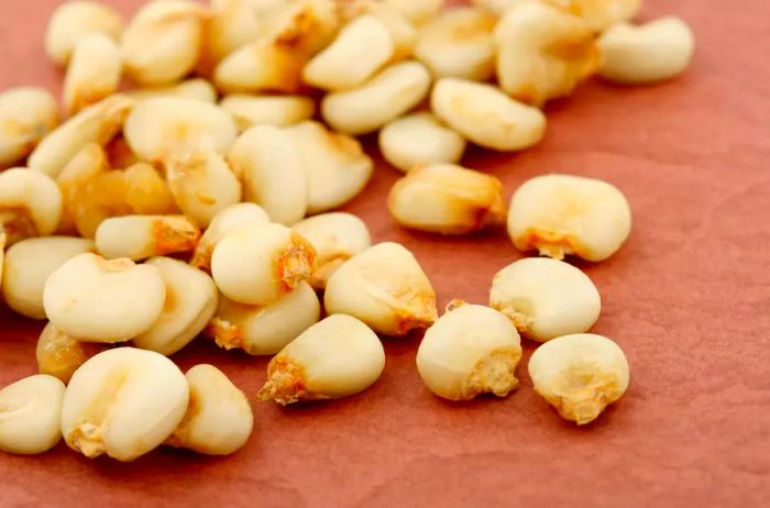 Yellow Hominy on a vibrant red backdrop