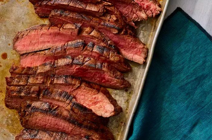 An overhead view of sliced, marinated flank steak