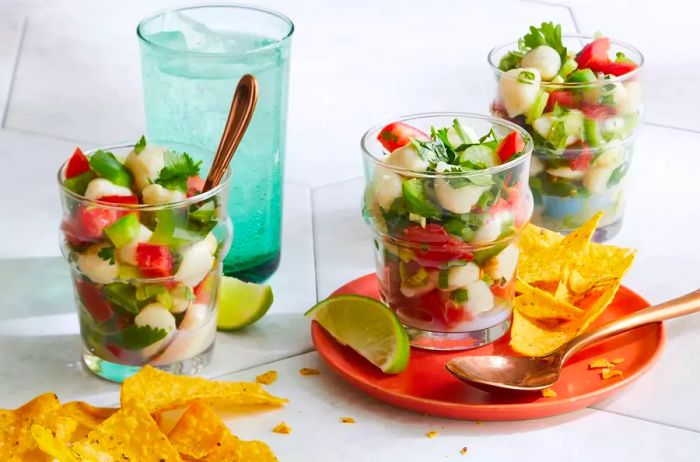 Individual servings of ceviche paired with crispy tortilla chips.