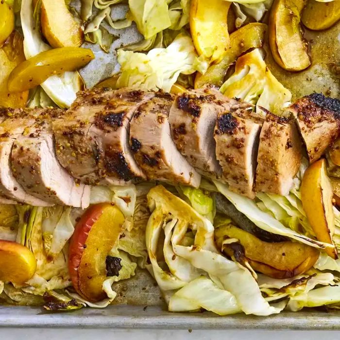 A sheet pan of Honey Dijon Pork with Apples and Cabbage