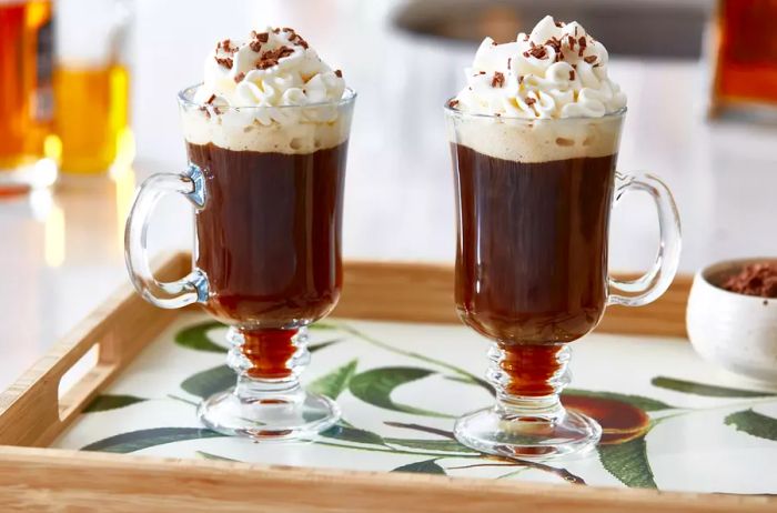 A traditional Irish coffee served in a glass mug with whipped cream