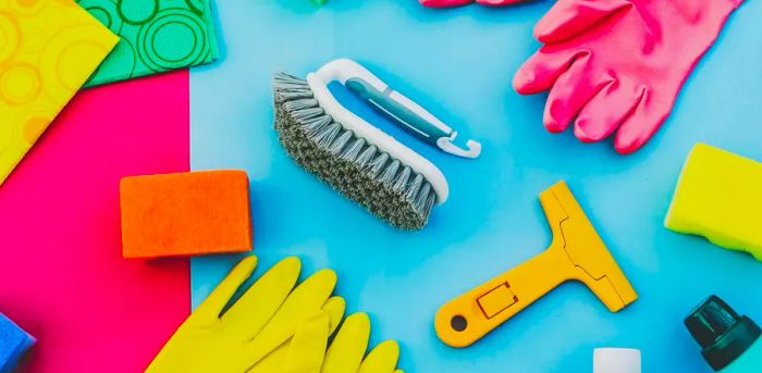 Various kitchen tools on a soft pink and blue backdrop